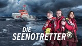 Drei Menschen vor einem Boot